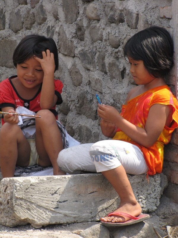 Passing out pencils to some children in the local village